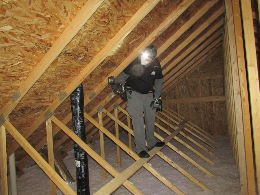 Technician doing a final check of an attic after mold removal