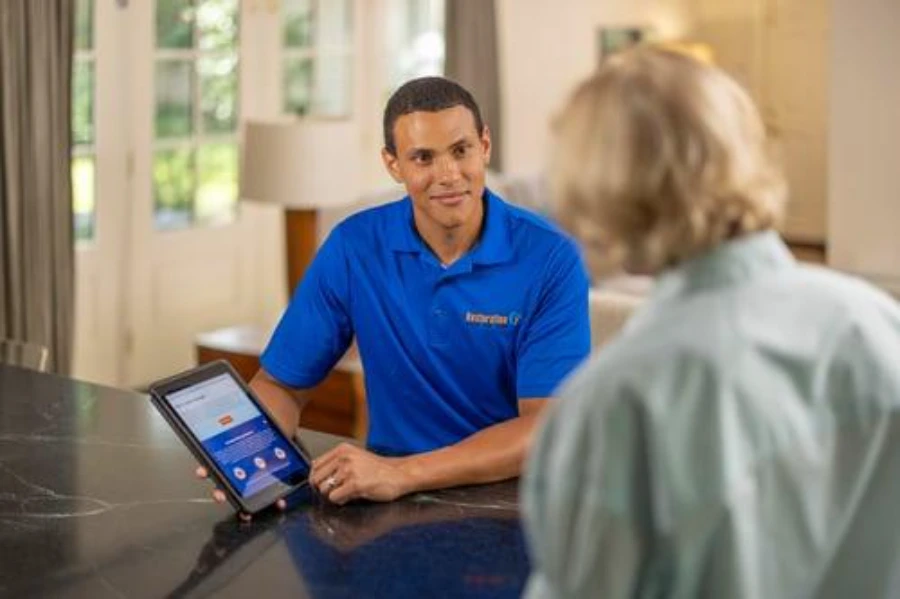 Technician reviewing a homeowner's mold concern before a remediation visit