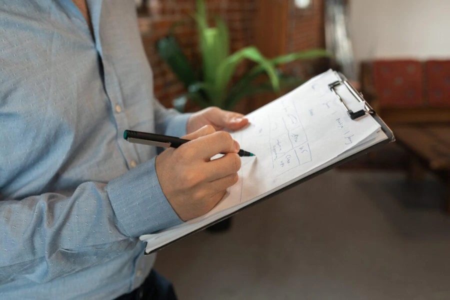 Technician reviewing written mold inspection findings with a homeowner
